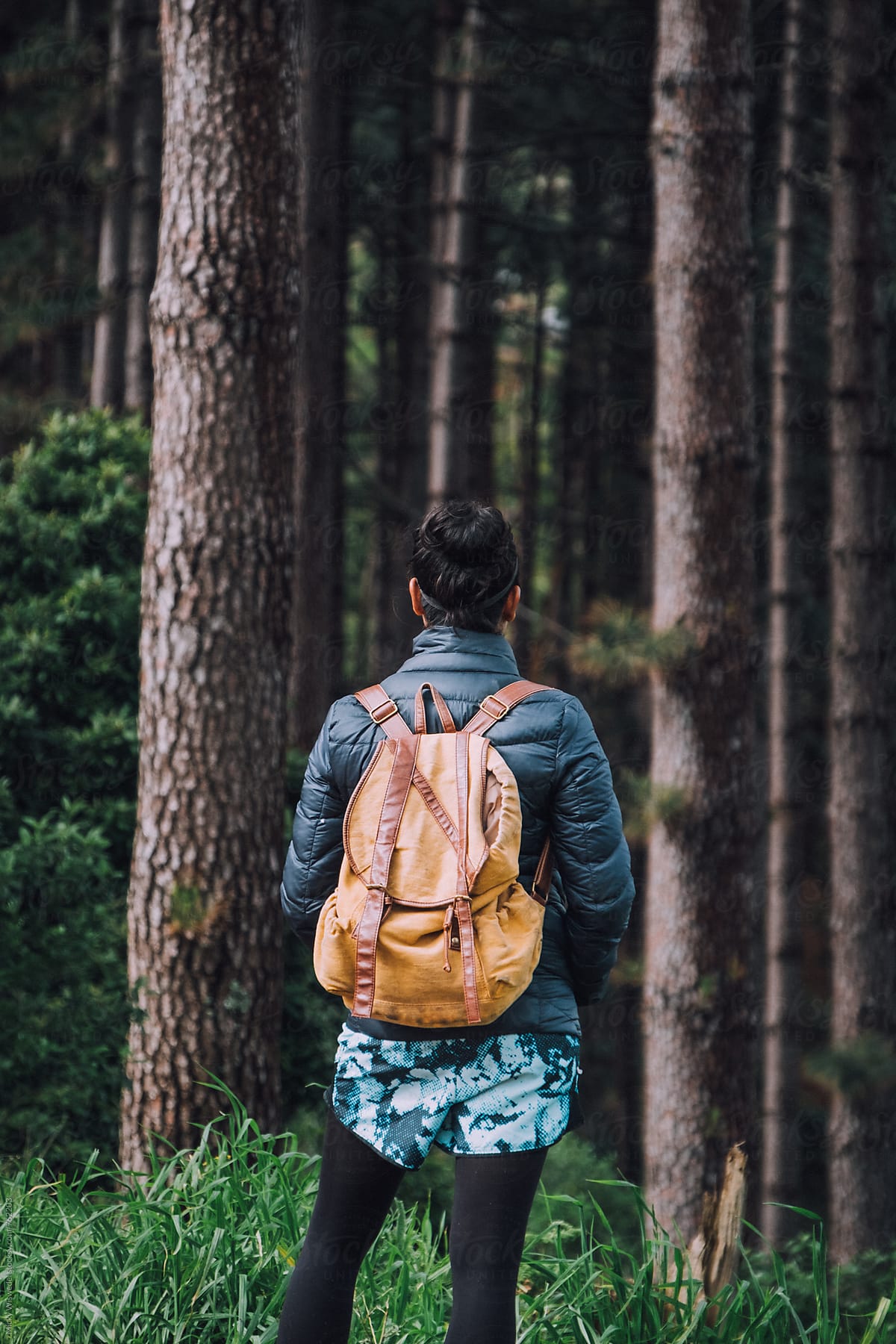 Woman with a backpack hiking in a forest