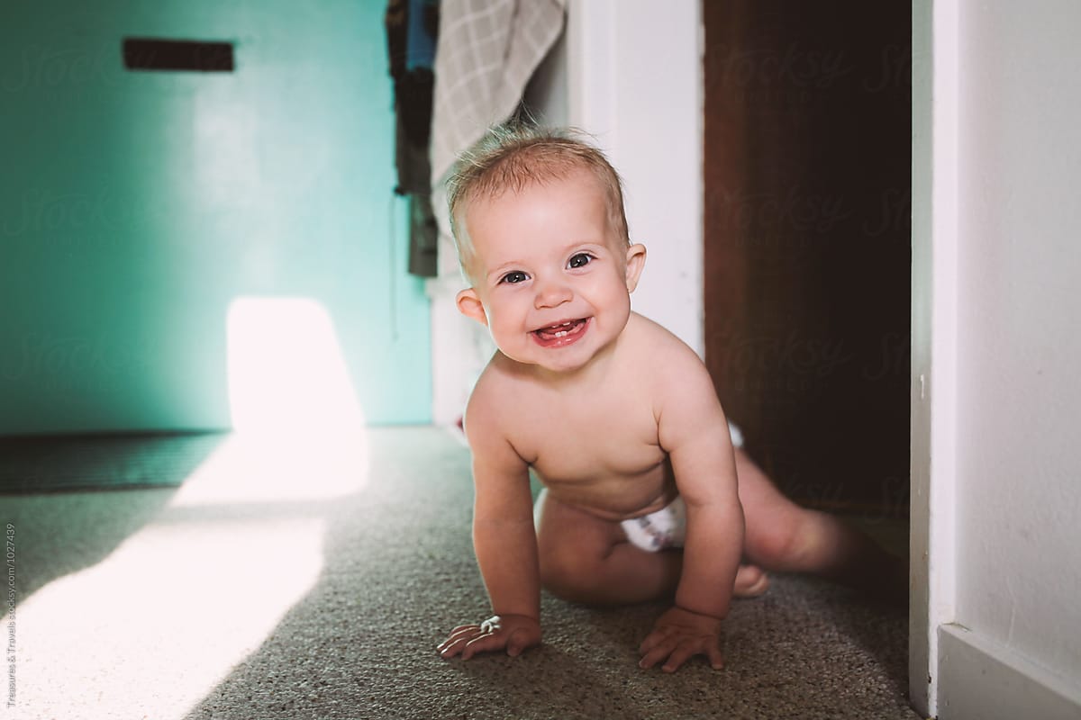 Happy Baby Crawling at Home in the Sunshine