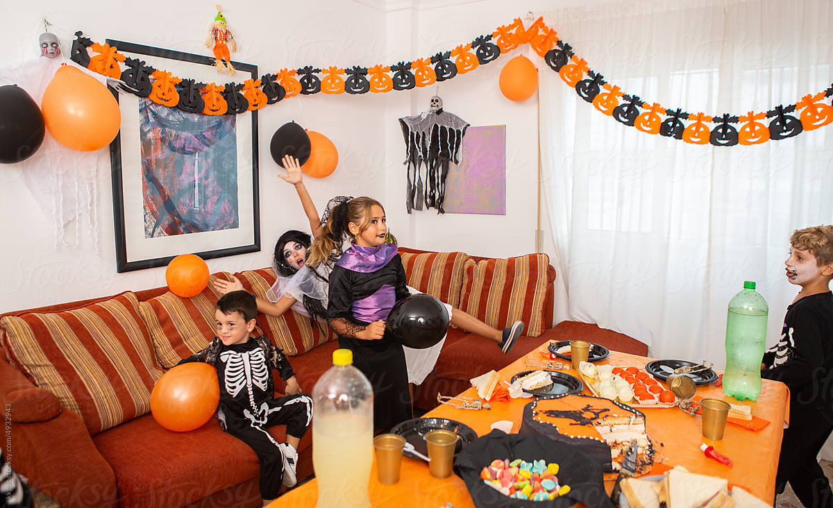 Children play with balloons at halloween party.