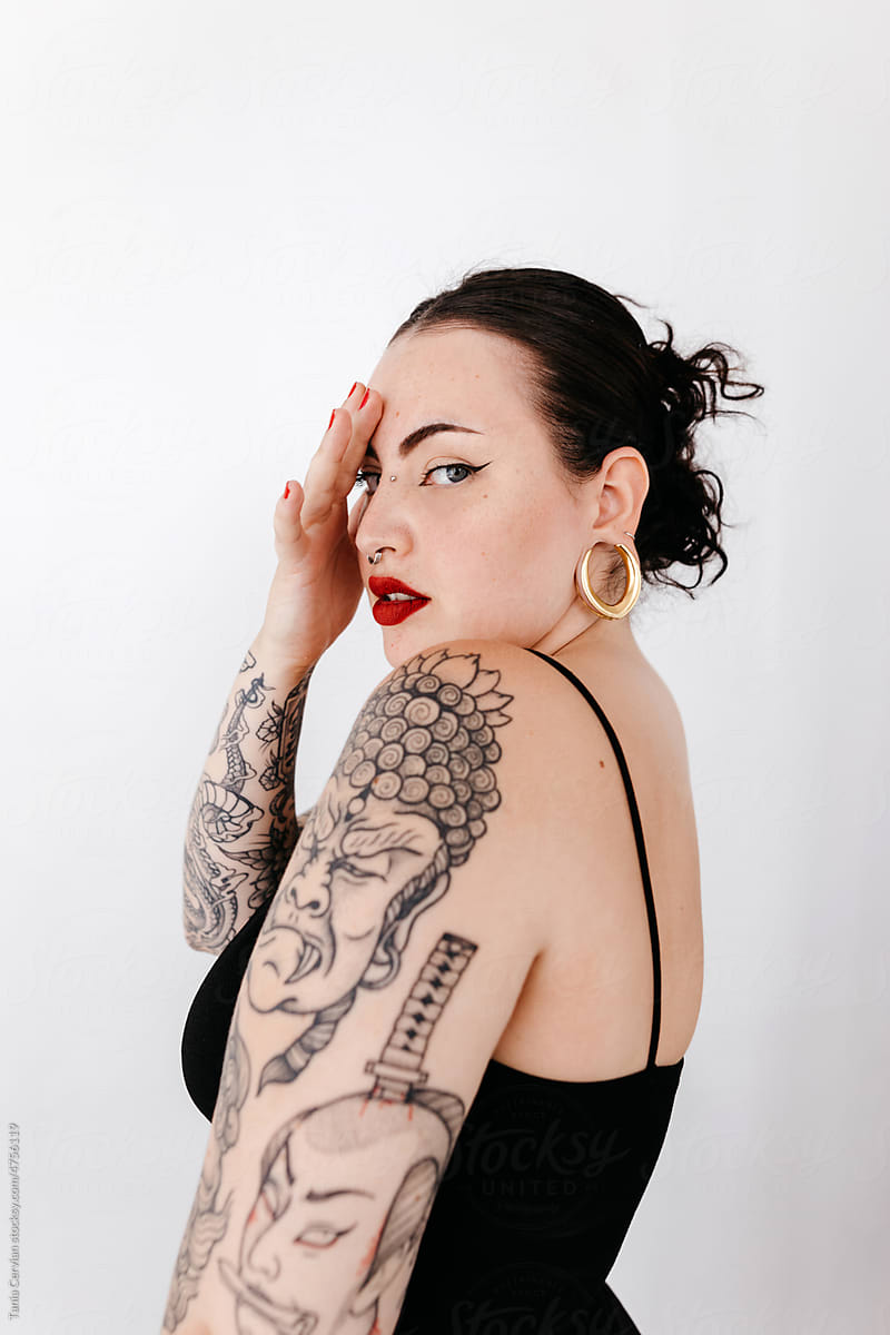 Tattooed woman covering half face