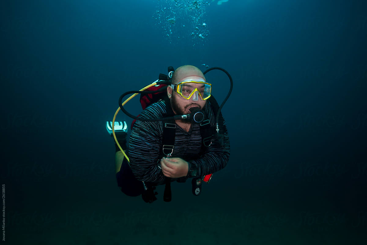 Portrait of a Scuba Diver in dark water