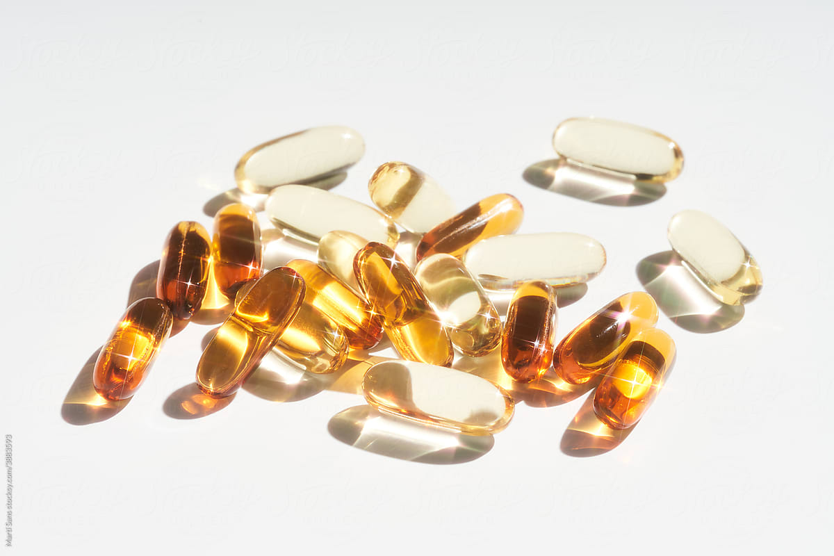 Pile of vitamin capsules on table