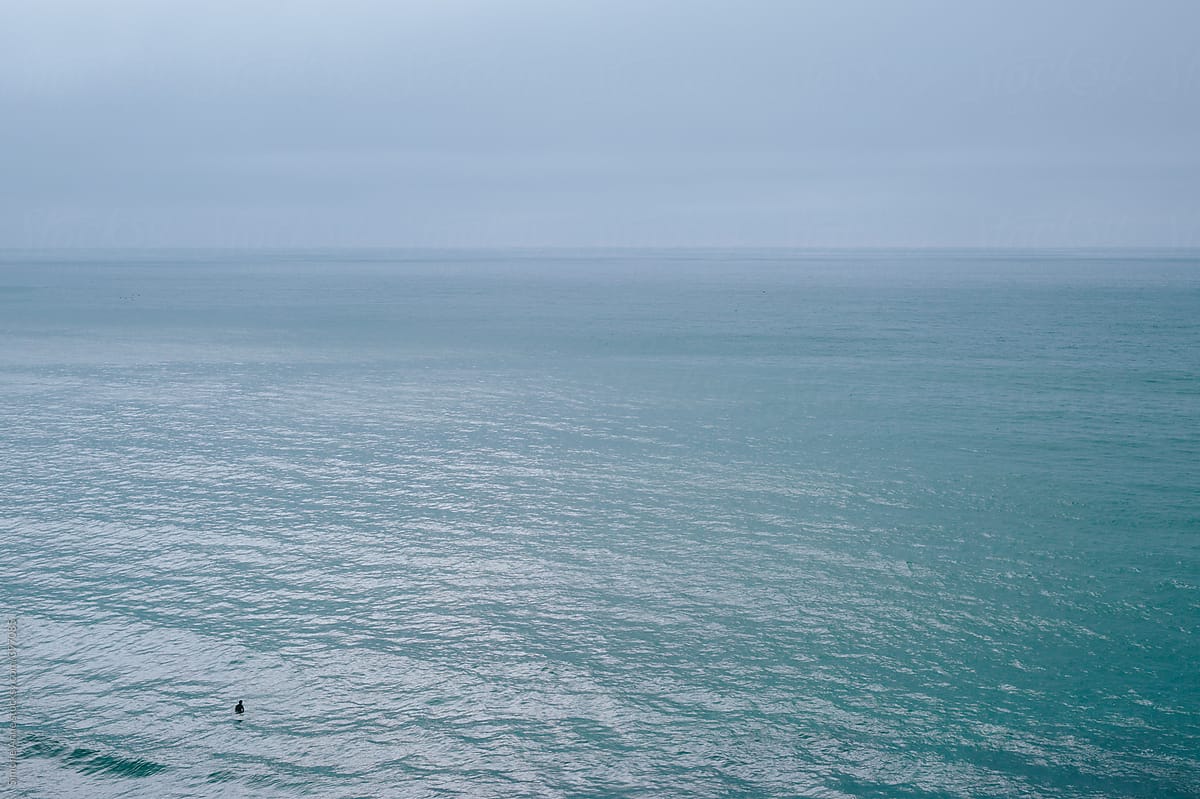 Surfer alone in large stormy ocean
