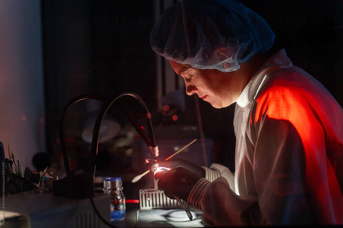 Scientist Working With Sample In Dark Lab Room