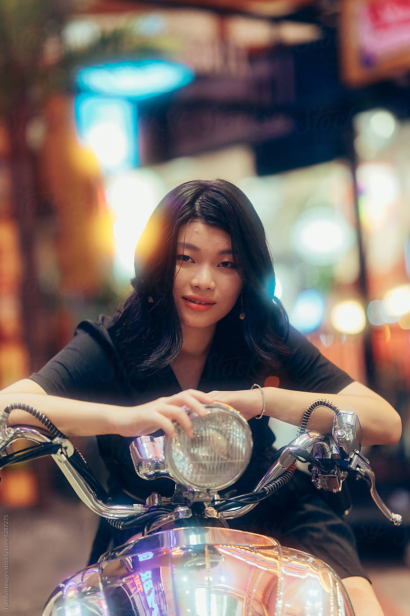 Asian female sitting on a motorcycle