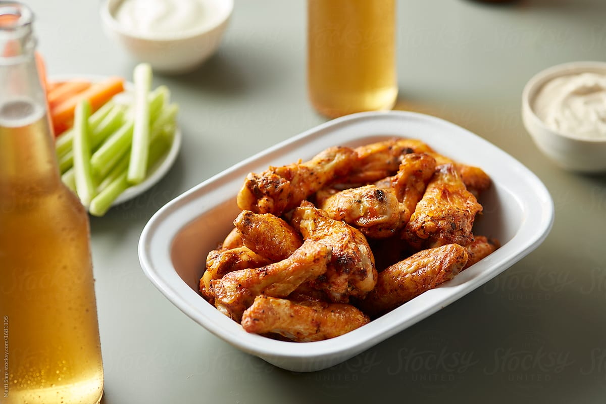 Chicken wings with celery and carrot.