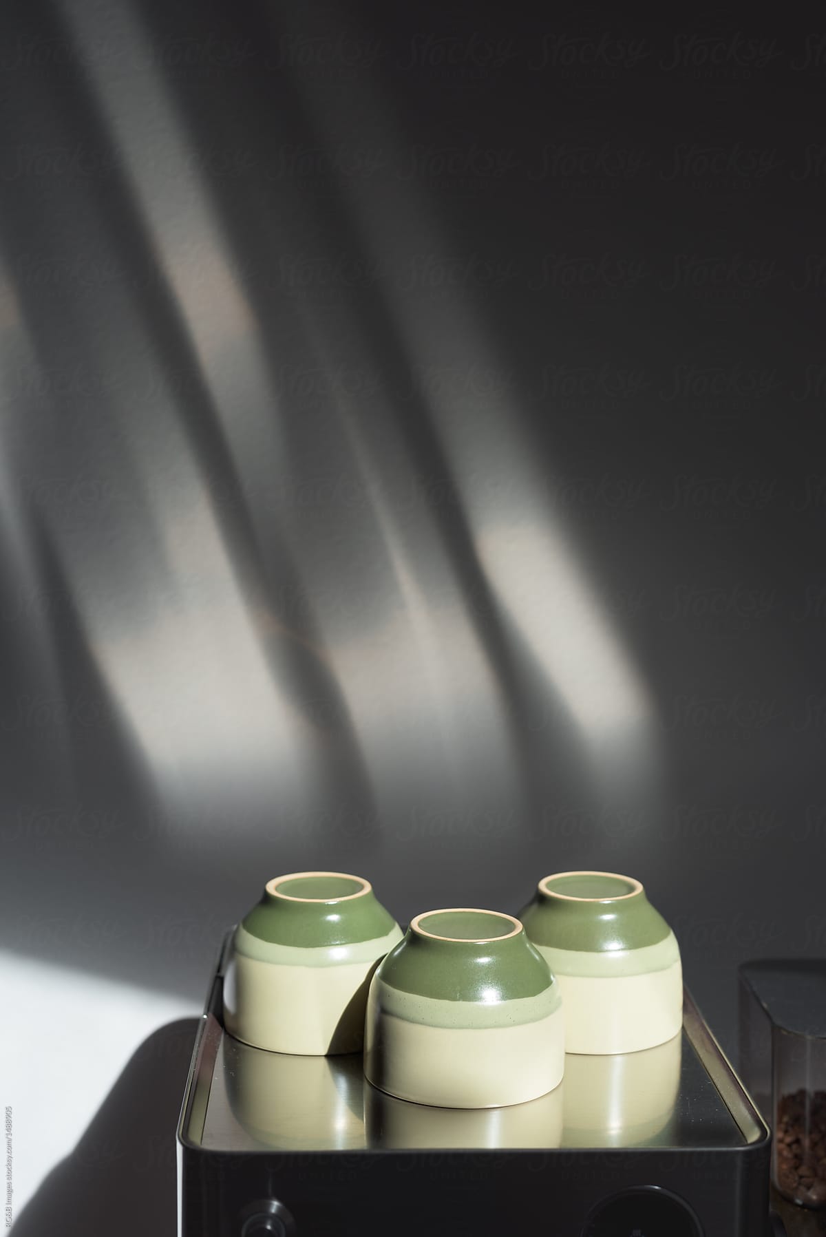  Three Coffee Cups Placed On Espresso Machine Del Colaborador De Stocksy Ibex media Stocksy
