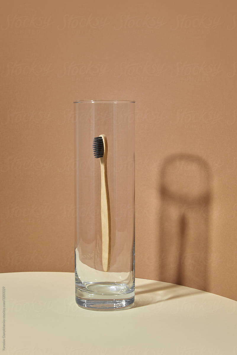 Floating wooden toorhbrush in a glass.