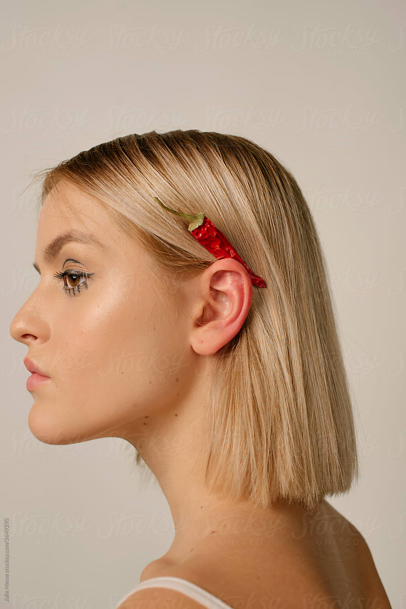 Blonde Woman With hot pepper behind her ear