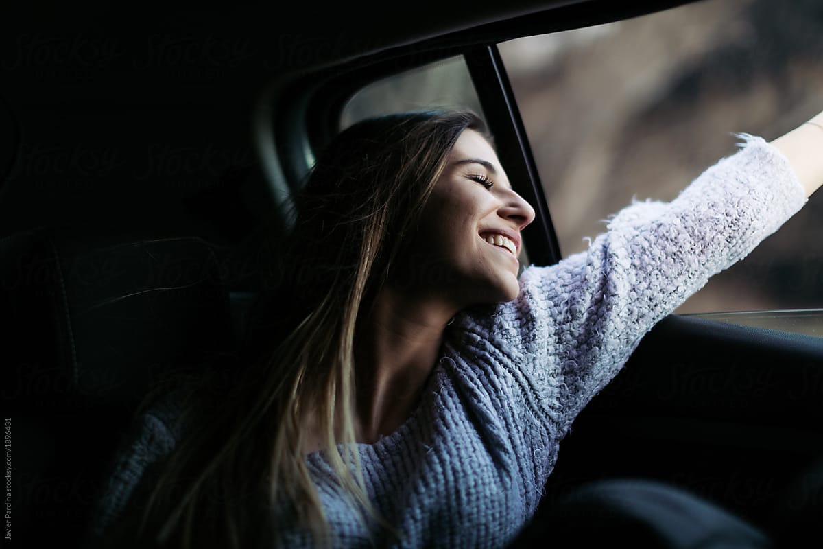 Younger woman thinking and enjoying at travel by car.