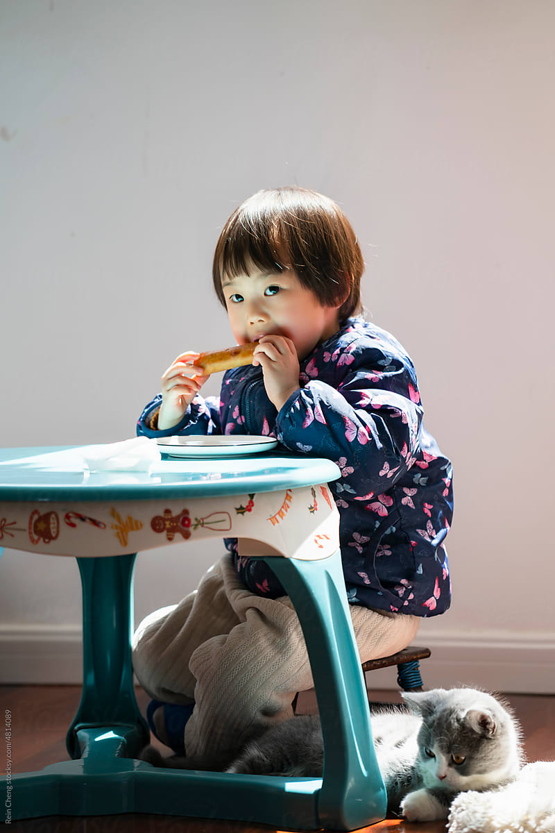 Asian baby eating spring rolls