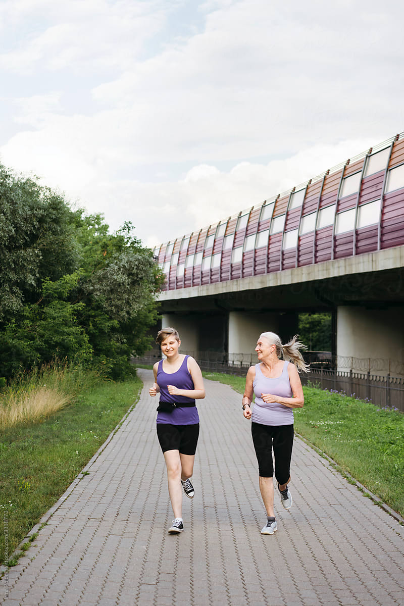 Grandma and granddaughter are engaged in jogging together.