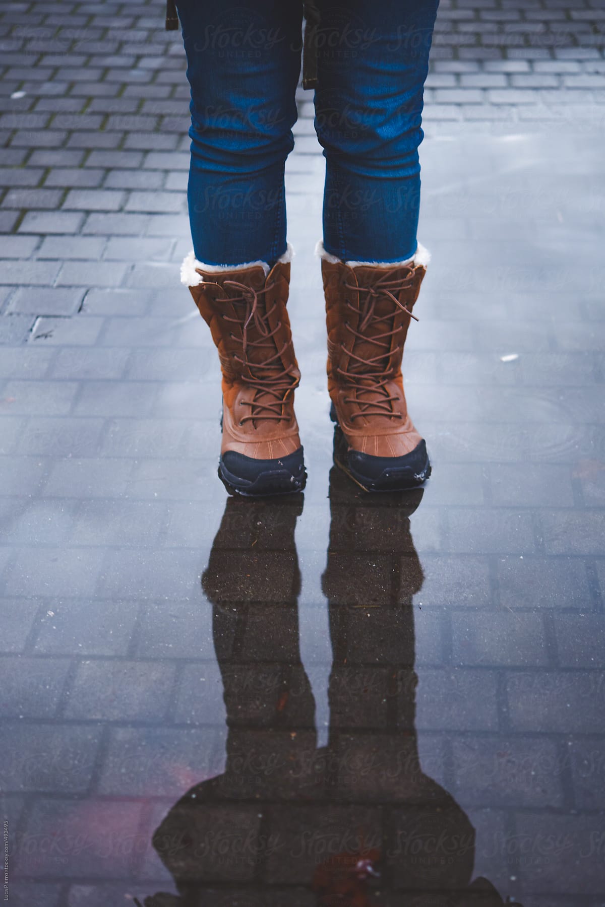 Woman boots in a puddle