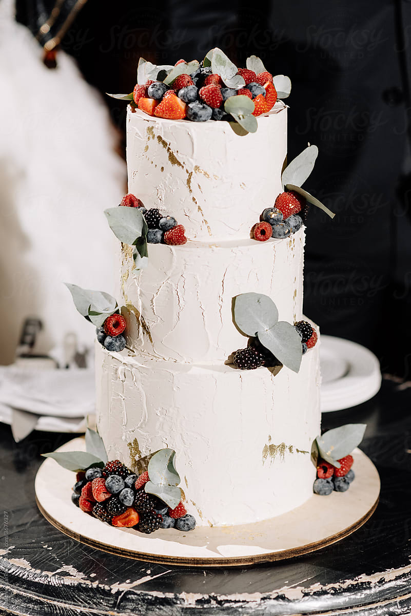 tiered wedding cake decorated with berries