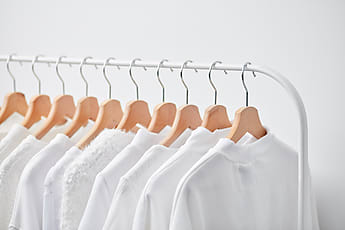 Collection Of Multicolored Clothing On Rack by Stocksy