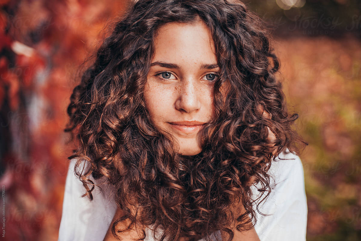 Girl With Brown Curly Hair And Blue Eyes