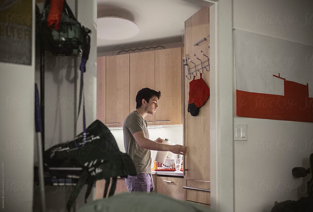 Mexican-American Male University Student Makes Breakfast in New York Apartment Kitchen