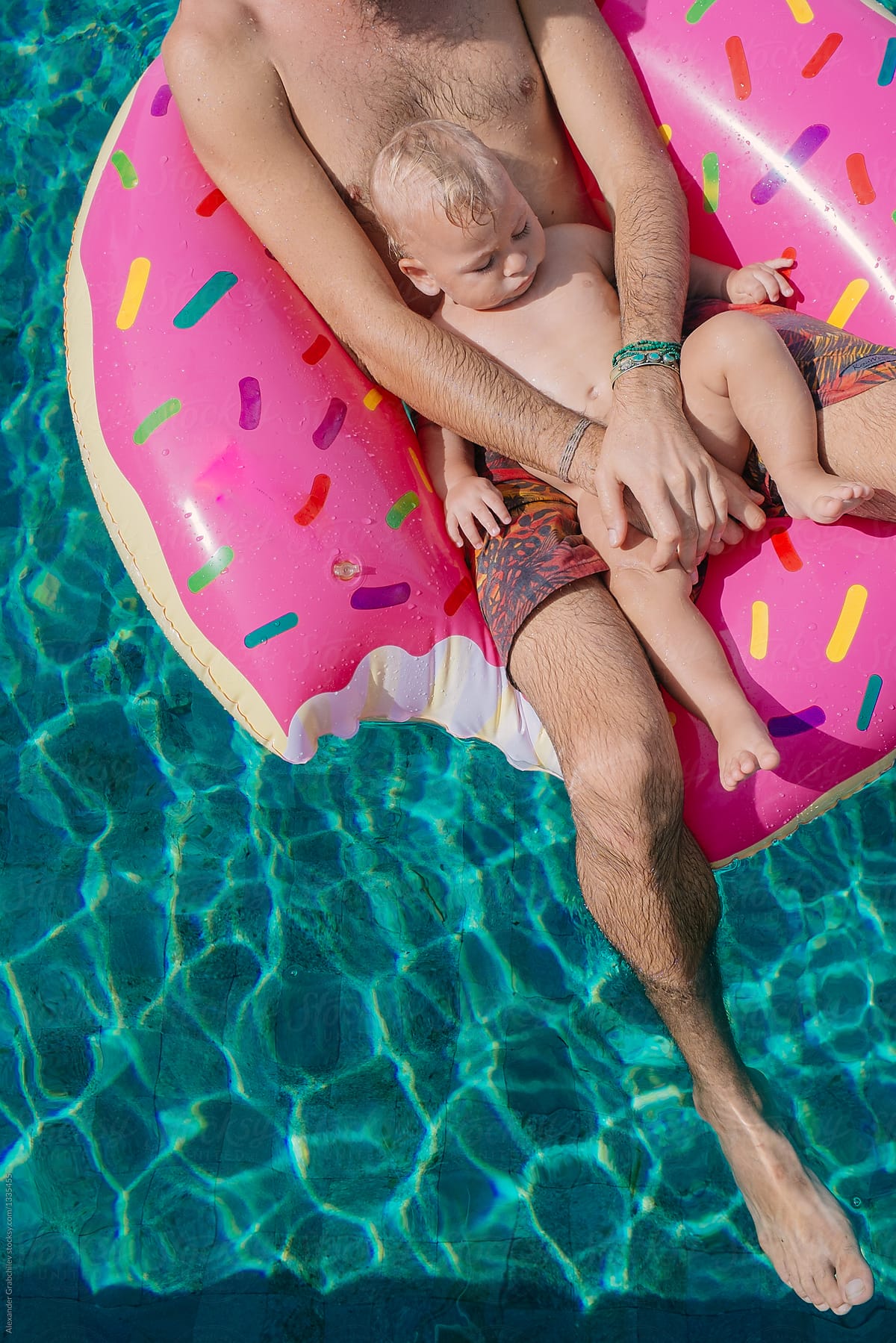 Father With Son Swimming In Pool