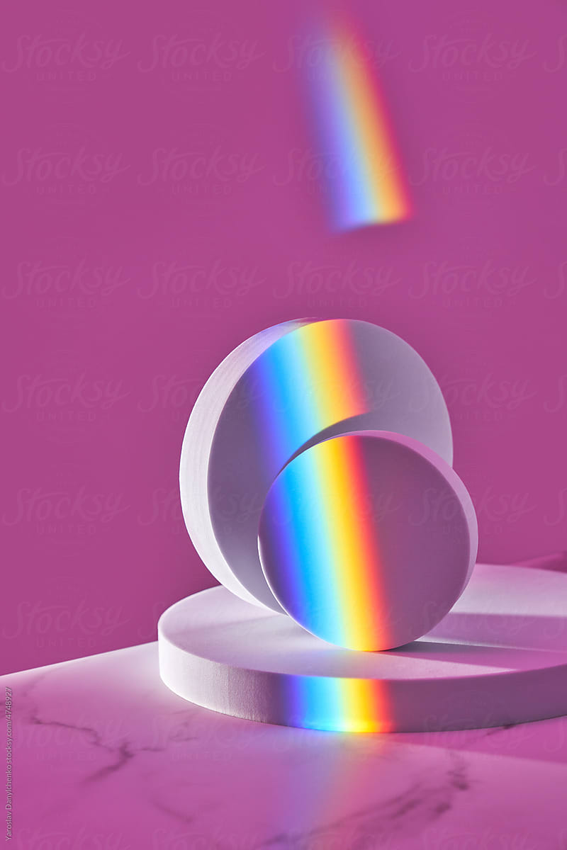 Round white figures in prism rainbow.