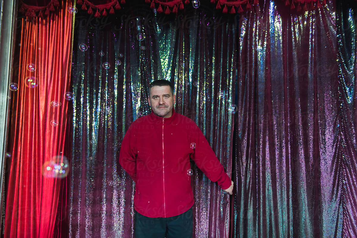 Circus Worker Posing In Glittering Curtain Background