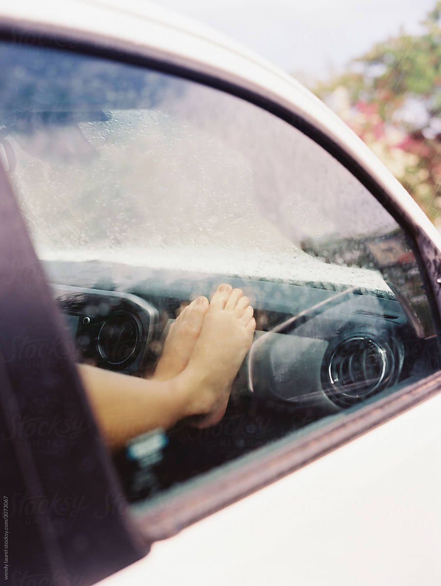 Feet on dashboard of car