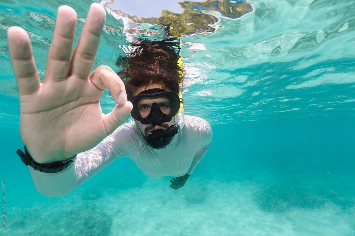 Man Showing OK Hand Signal Underwater