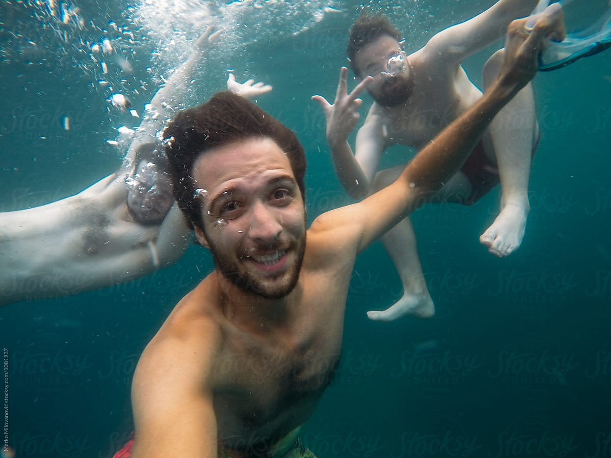 Young male friends having fun in the sea