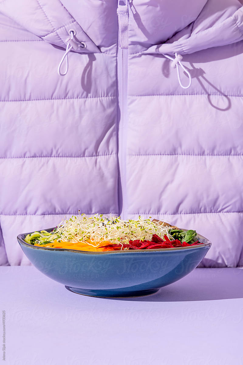 Colorful vitamin salad and the purple jacket. Immunity or vegan food.