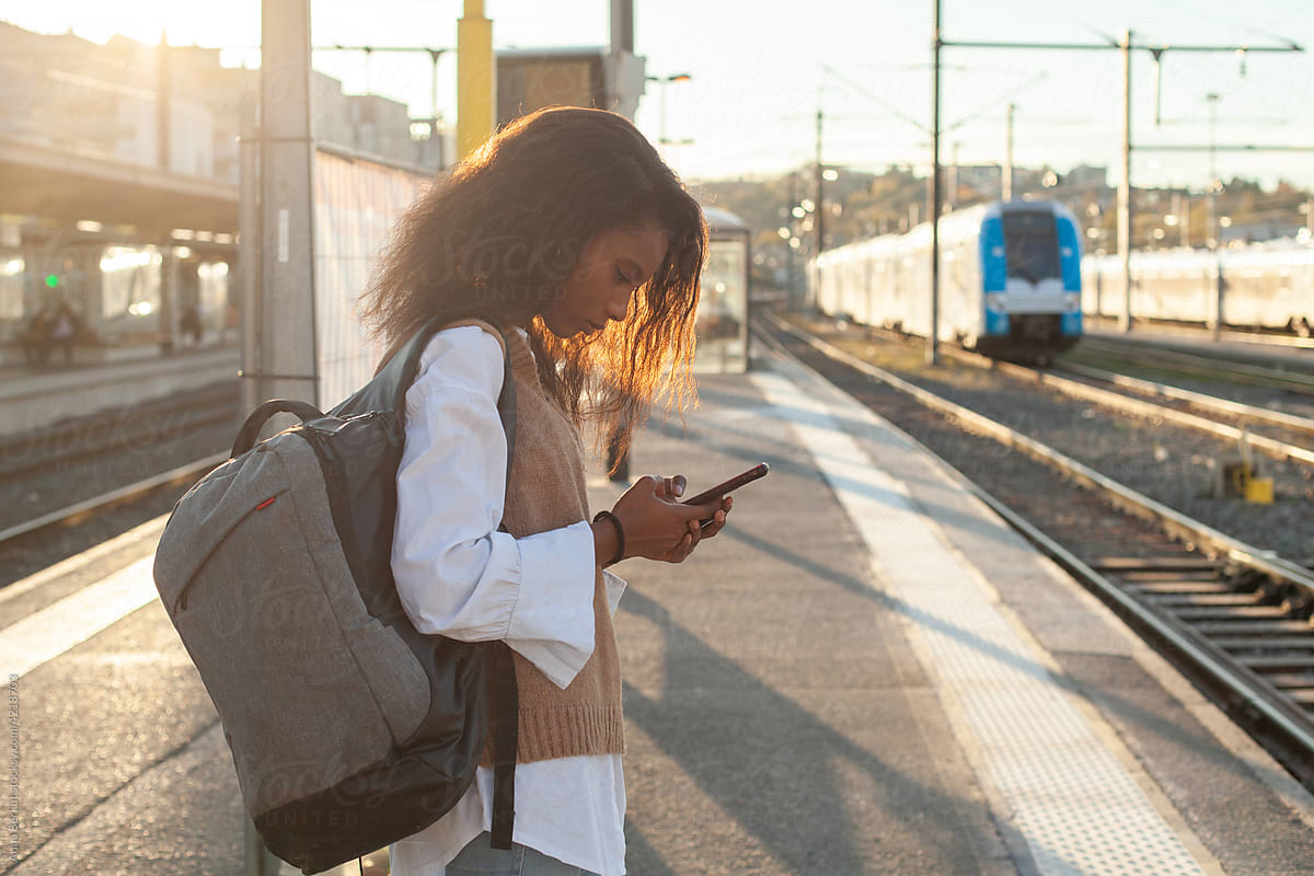 transport, black woman passenger on railway station waiting for train
