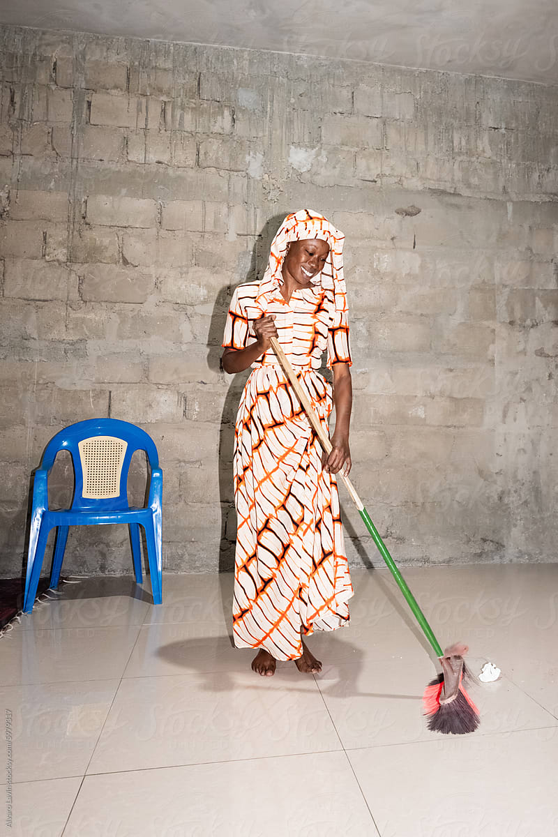 Senegalese Woman Sweeping Indoor Space