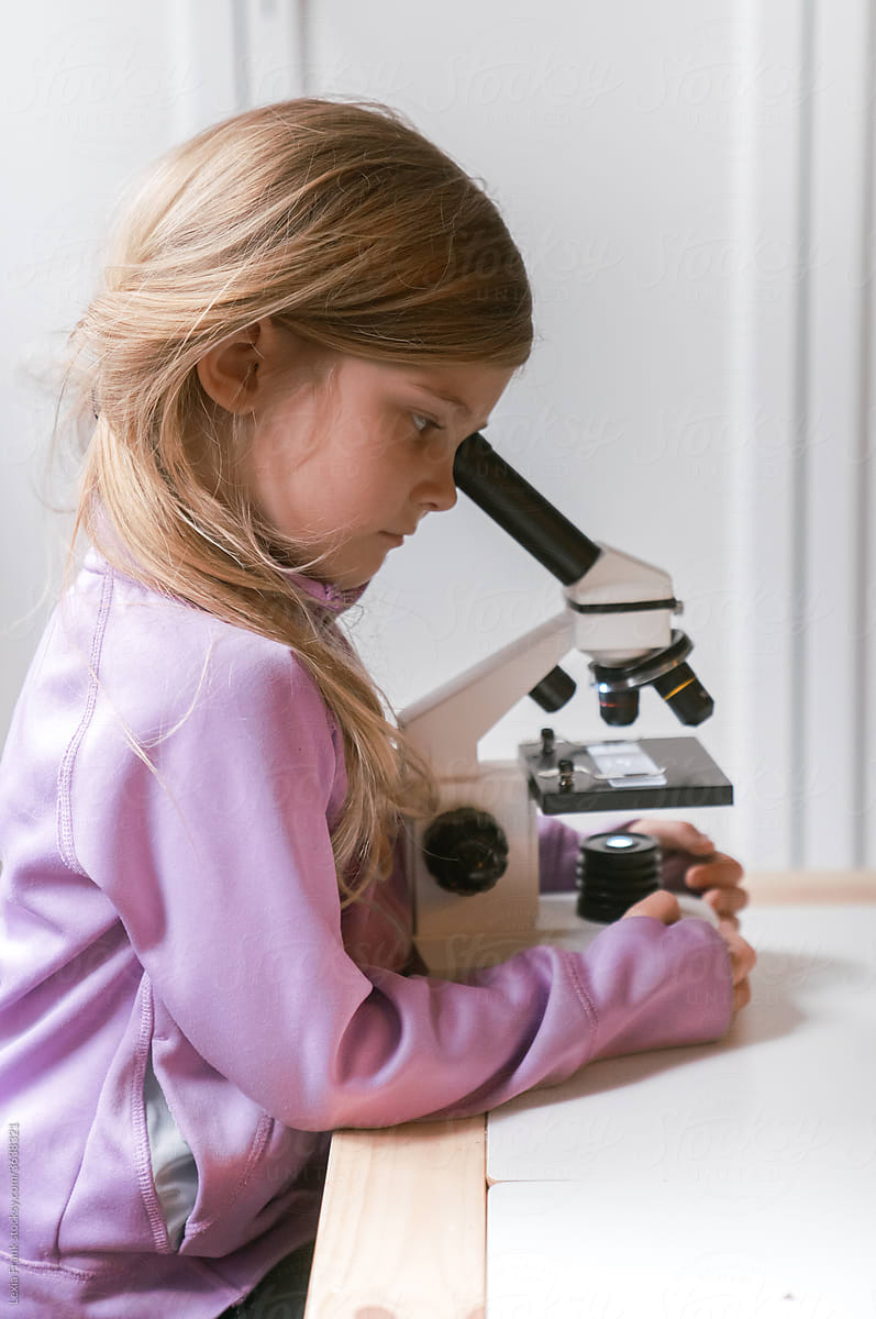 little girl uses microscope 2