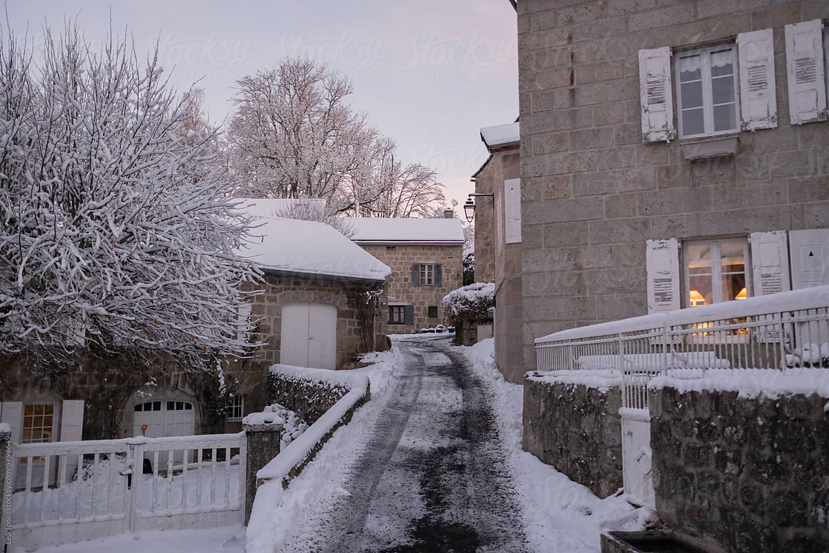 ice covered road going through a snowy French village