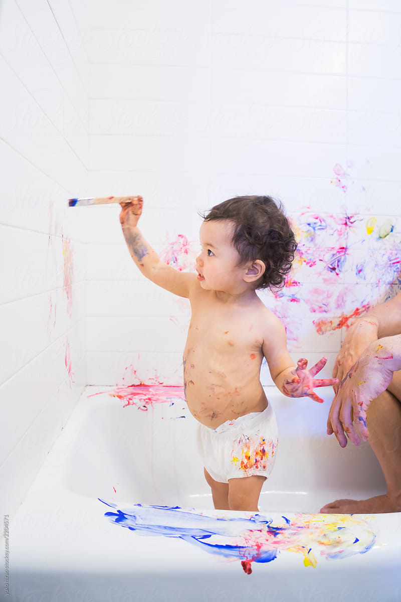 Toddler girl, painting bathroom walls
