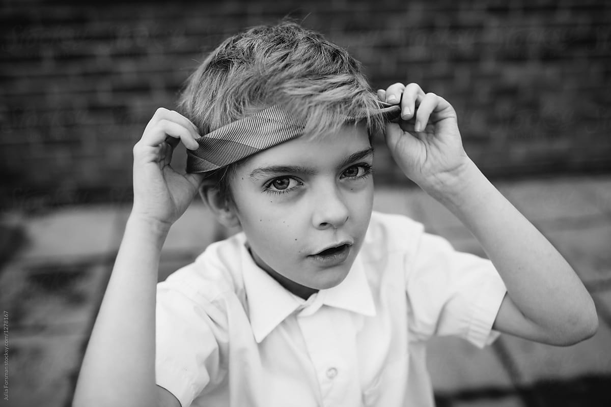 Young rebel wraps his school tie around his head.