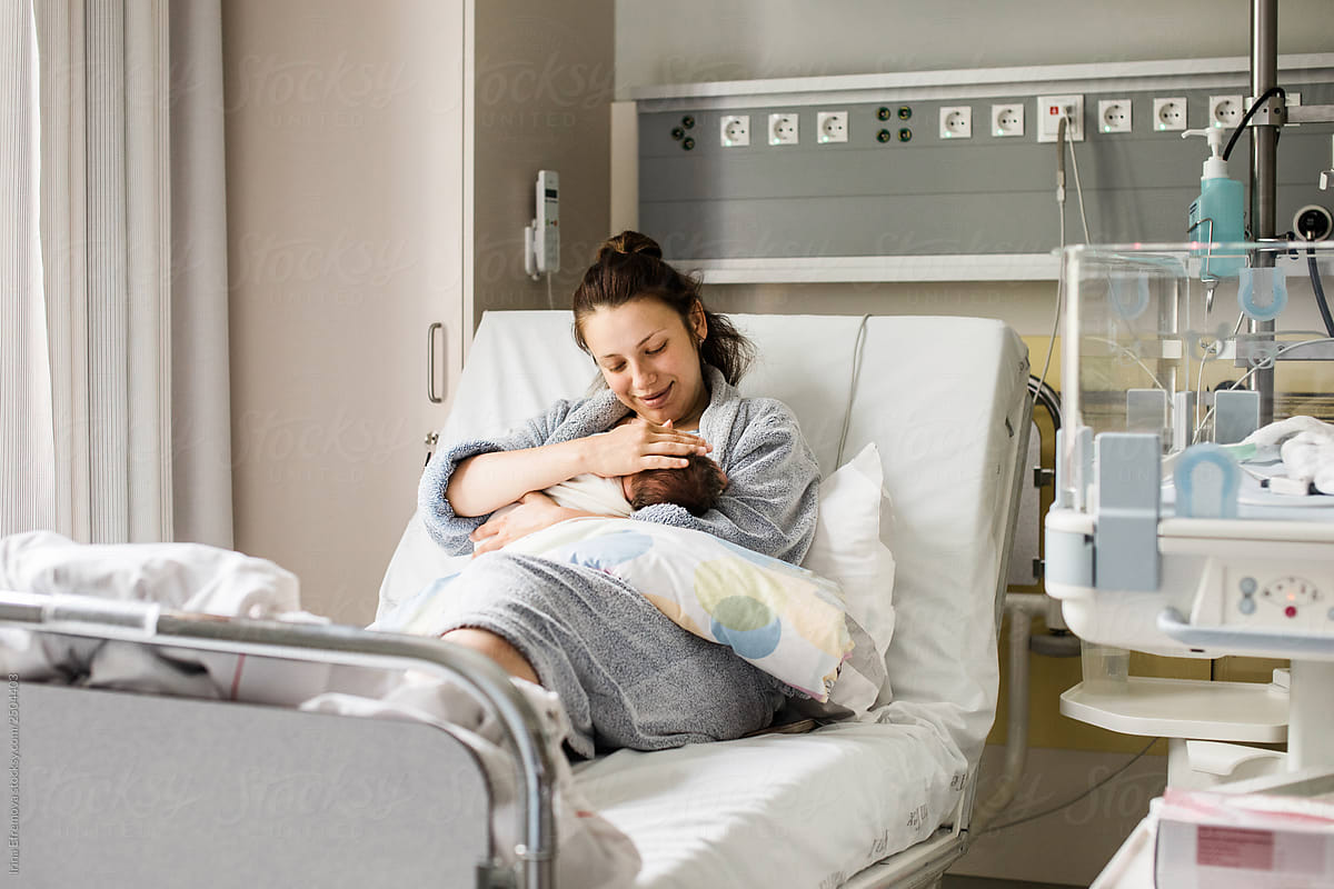 Mother breastfeeding a newborn in a hospital
