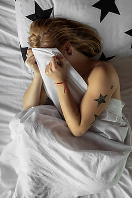 Tattooed Young Woman Sleeping In A Bed by Stocksy Contributor Mihajlo  Ckovric - Stocksy
