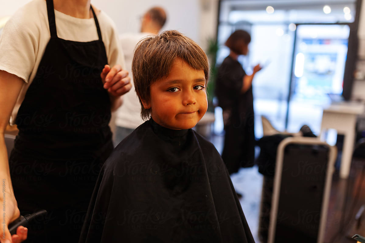 Boy getting haircut at hairdressing