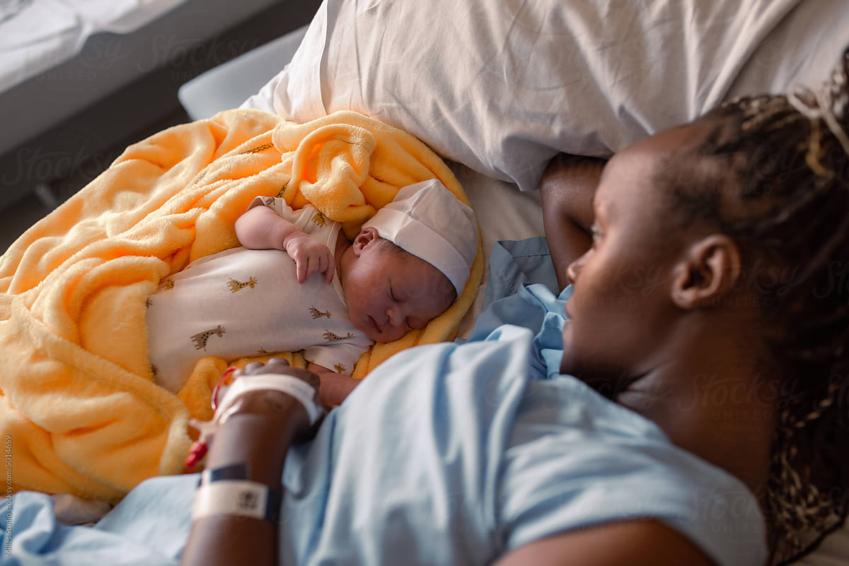 Black mother admiring newborn baby