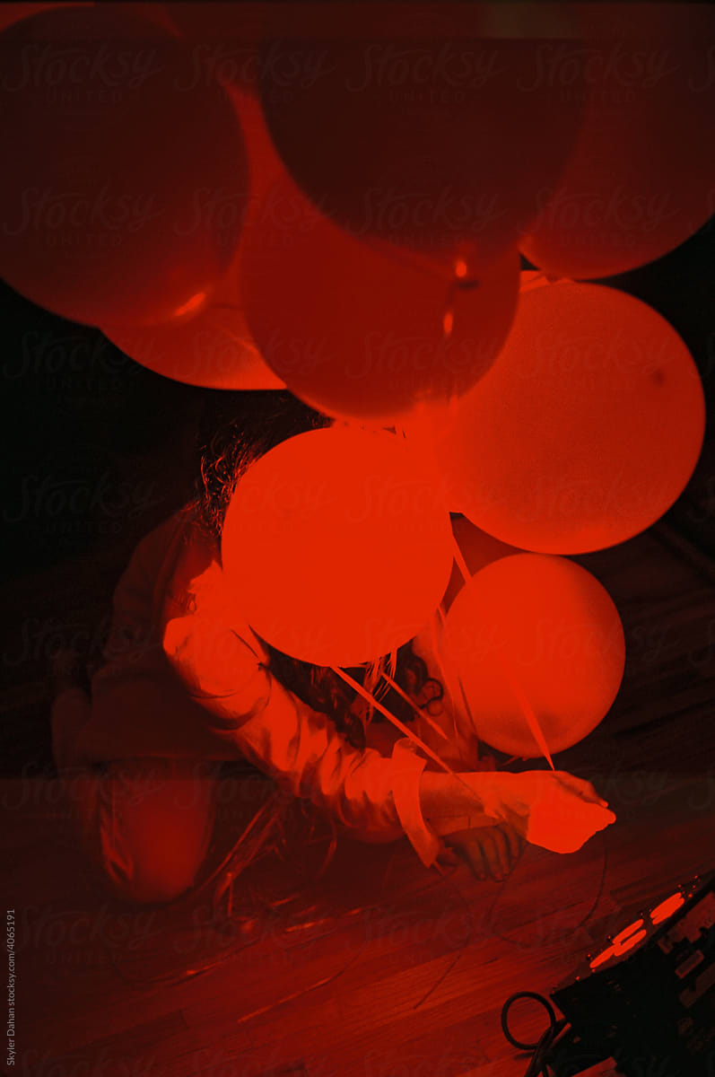 Someone Hiding Behind Red Balloons