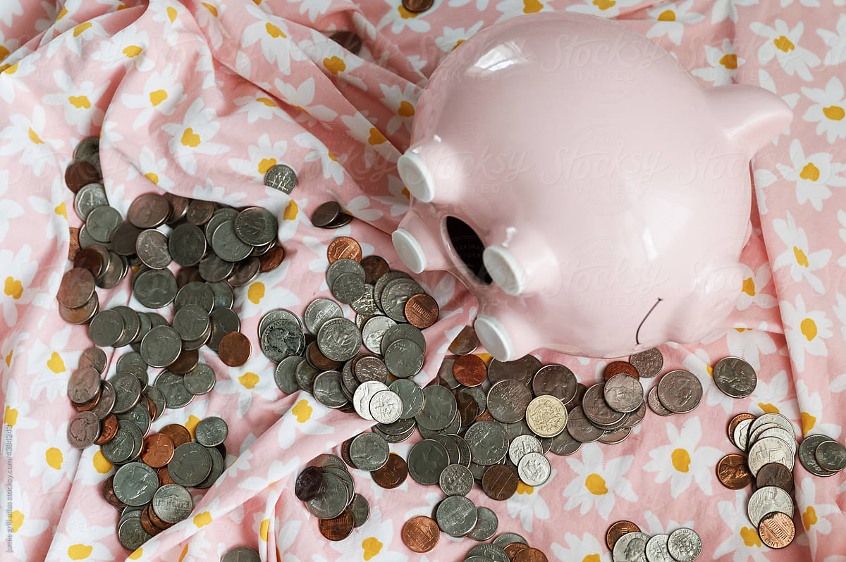 Piggy Bank Opened on a Child\'s Bed