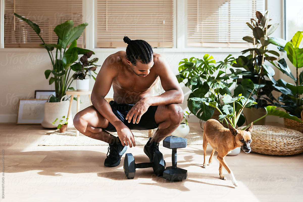 Ethnic dog owner resting during fitness training