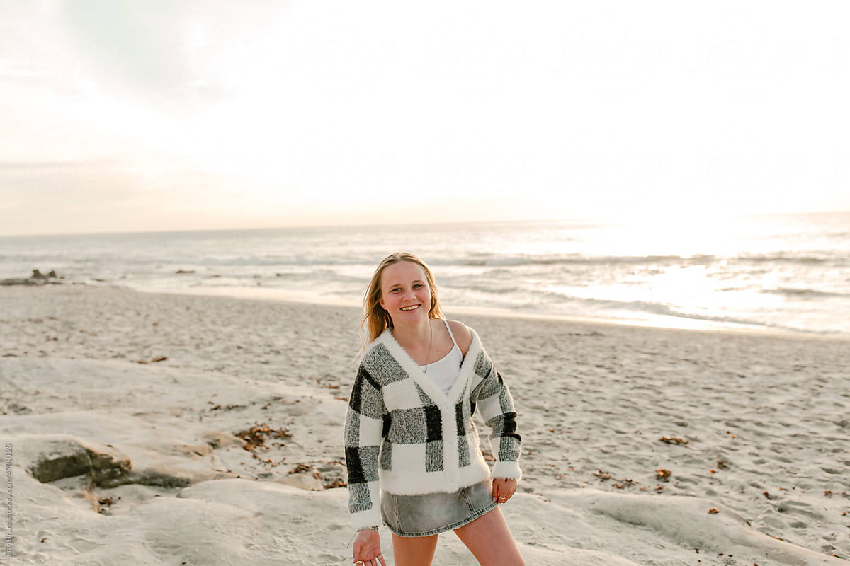 Smiling Teenager in a sweater at a west coast beach at sunset
