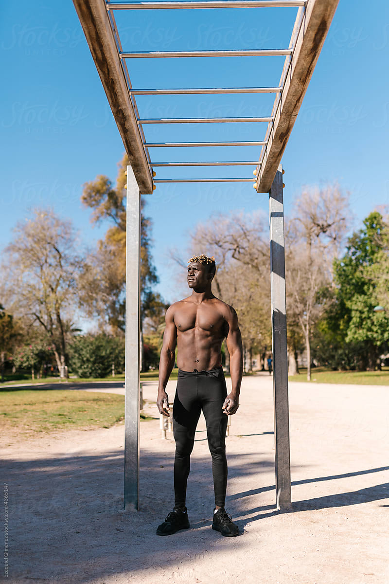 Shirtless black male athlete resting during training