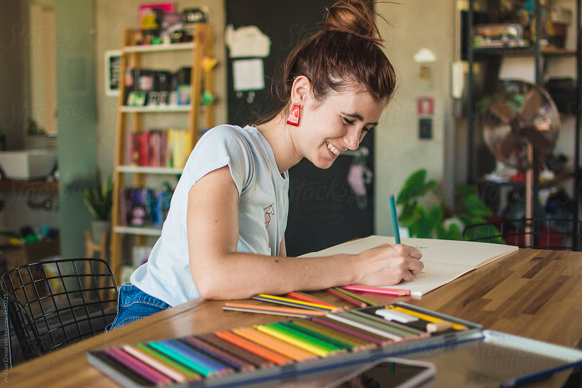 Woman smiling during an adult coloring book session