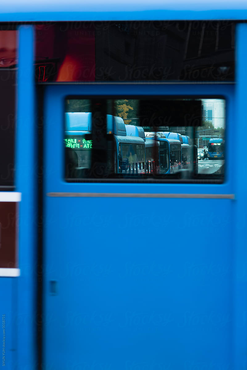 Blue bus and red face