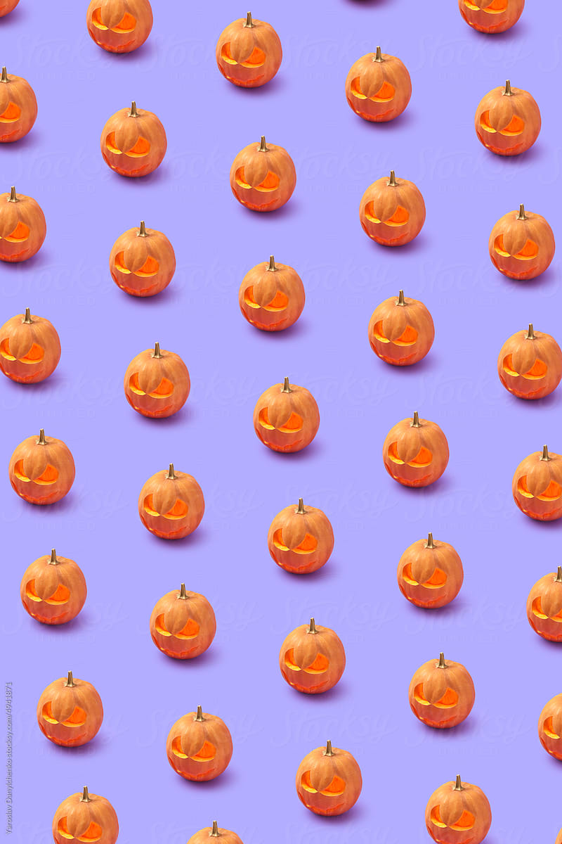 Pattern of Halloween pumpkin on lilac background.