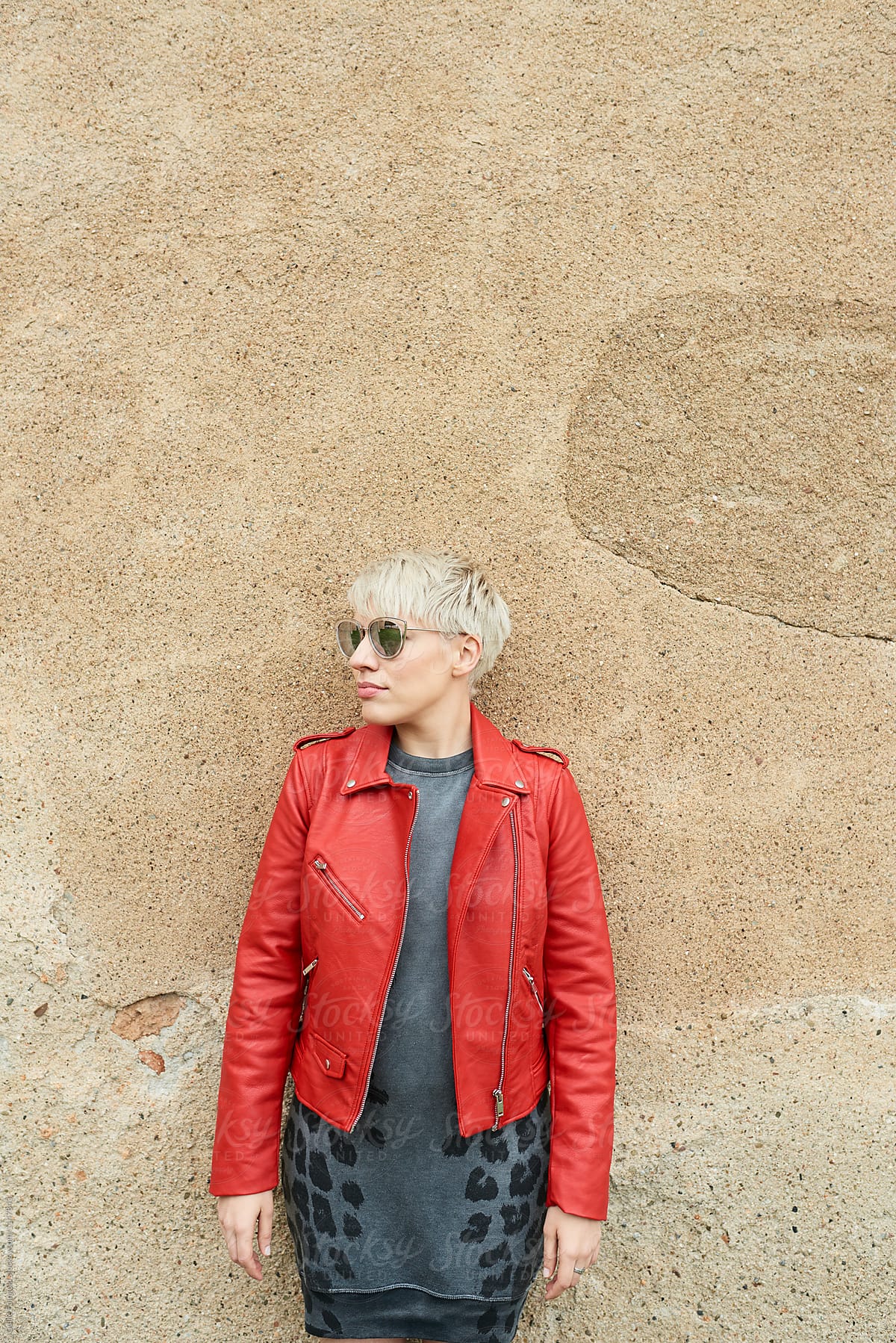 short-haired blonde in red jacket and dress