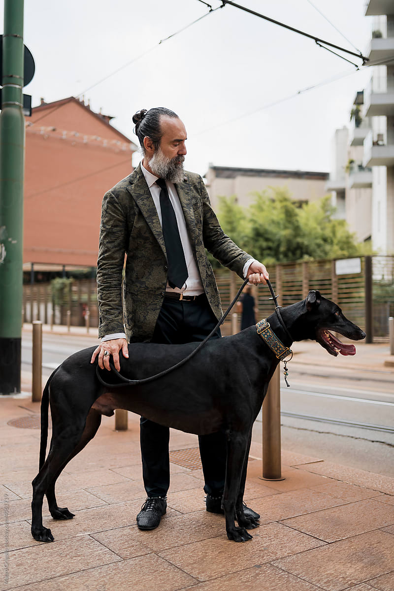 Adult Man outdoor with his dog in town