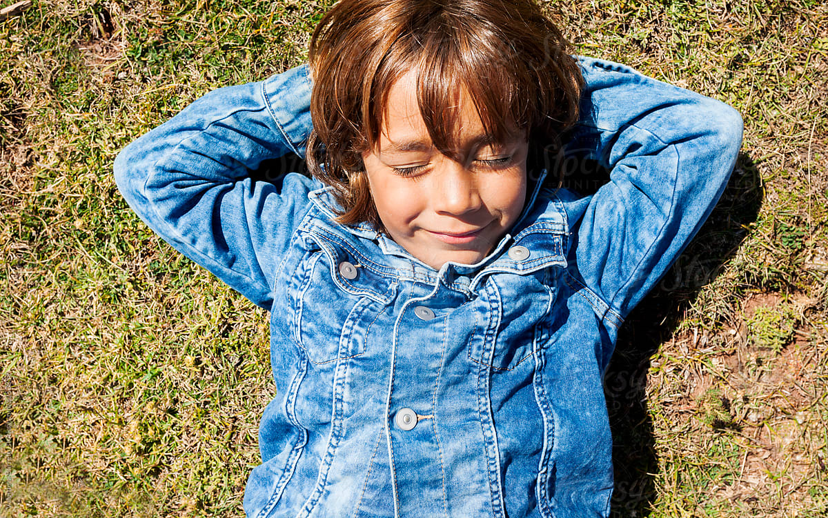 joyful kid relaxing in the grass