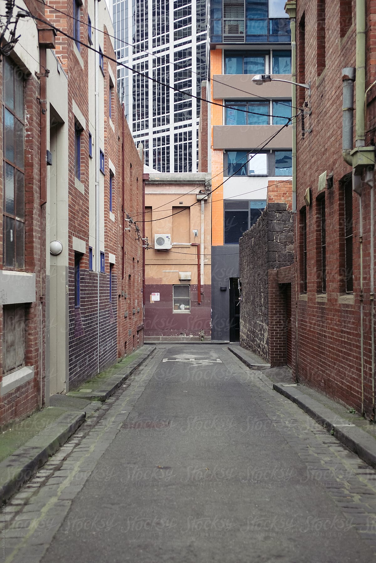 Old narrow laneway with new modern office buildings in background